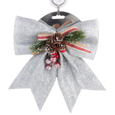 X-mas Holly Ribbon – Silver Decorative Christmas Bow (20×25cm) with holly, pine cones, and red accents.